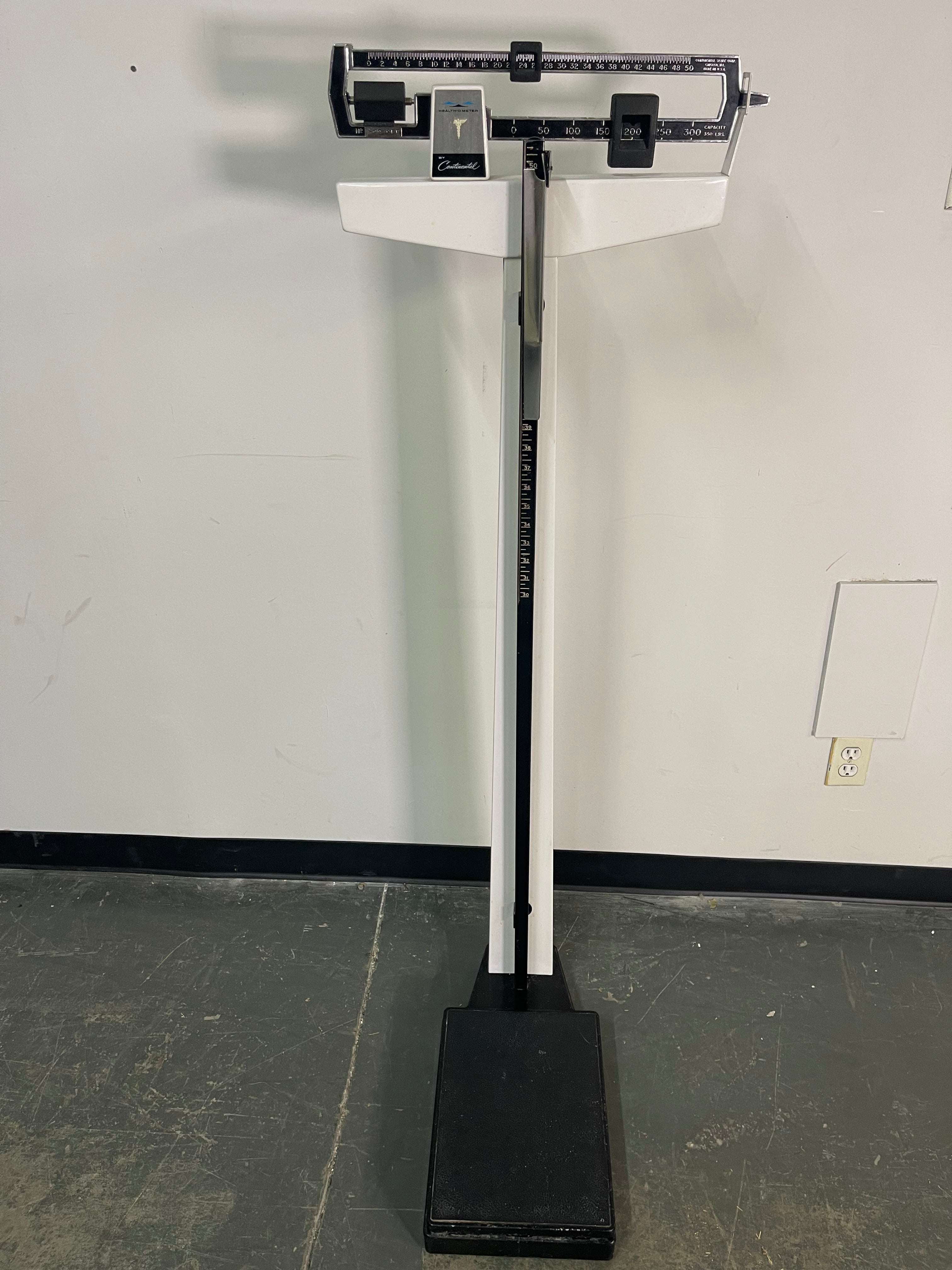 Measurement device attached to a door in a room with a whiteboard.